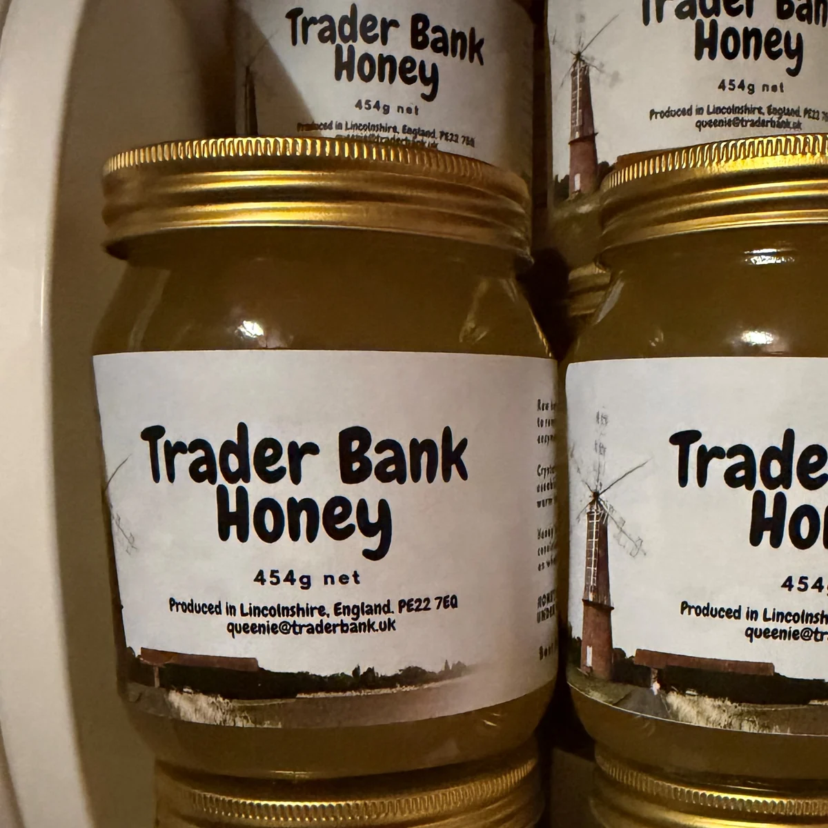 Jars of TraderBank honey featuring our local windmill label